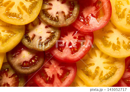 Fresh Colorful Tomatoes Sliced into Juicy Pieces, Full Frame Macro Top View 143052717