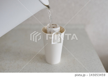 Kettle Pouring Water Over Paper Pour Over Coffee Filter Resting In White Disposable Cup On Speckled Kettle Pouring Water Over Paper Pour Over Coffee Filter Resting In White Disposable Cup On Speckled 143053459