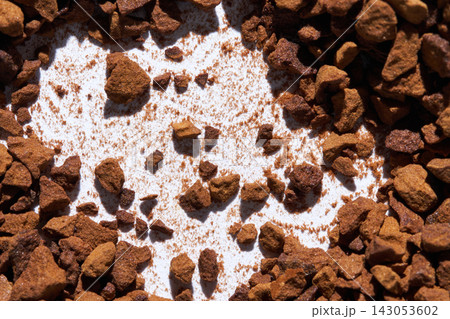 Instant Coffee Granules Scattered Across White Paper With Irregular Pile And Exposed Background 143053602