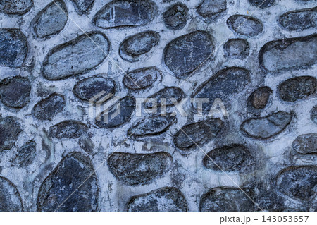 Natural Stone Wall Texture Background with Grey Pebbles and Cement 143053657