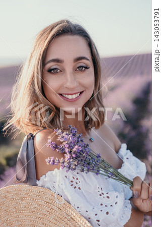 Lavender woman smile happy woman holds purple bouquet in fragrant field during summer sunset vacation portrait Lavender woman smile happy woman holds purple bouquet in fragrant field during summer sunset vacation portrait 143053791