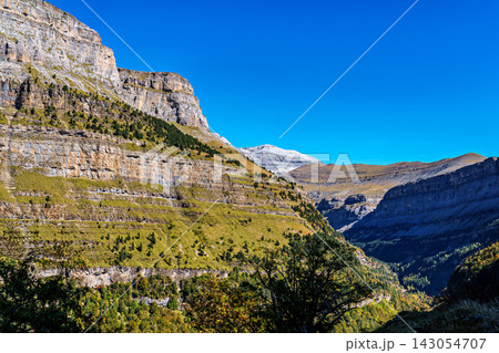 Walking on the Hunter's Trail, Senda de los Cazadores in autumn. Ordesa and Monte Perdido Natural Park, Pyrenees, Spain 143054707