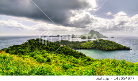 High angle panoramic view over lush green hills, turquoise ocean waters, and neighboring islands in Terre-de-Bas, les Saintes, Guadeloupe. High angle panoramic view over lush green hills, turquoise ocean waters, and neighboring islands in Terre-de-Bas, les Saintes, Guadeloupe. 143054977