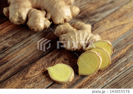 Ginger root on an old wooden table. Ginger root on an old wooden table. 143055578