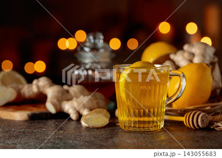 Cup of ginger tea with lemon, honey, and ginger root. Cup of ginger tea with lemon, honey, and ginger root. 143055683