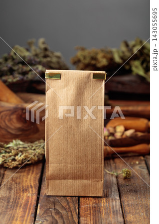 Tall brown paper bag on an old wooden table. Tall brown paper bag on an old wooden table. 143055695