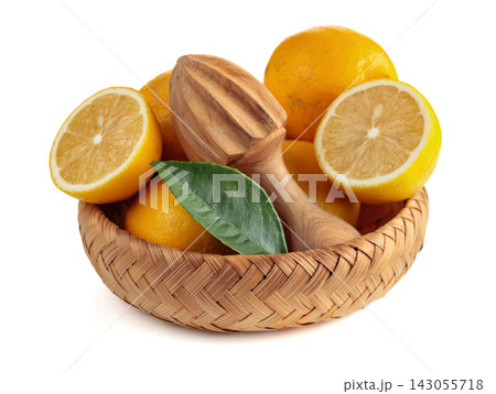 Fresh lemons and wooden juicer isolated on a white background. Fresh lemons and wooden juicer isolated on a white background. 143055718