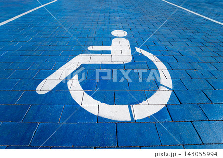 Handicapped symbol painted on a special parking space for disabled people Handicapped symbol painted on a special parking space for disabled people 143055994