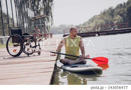 Person with a physical disability ride on sup board Person with a physical disability ride on sup board 143056477