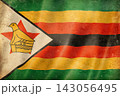Old vintage flag of Zimbabwe, worn and stained 143056495