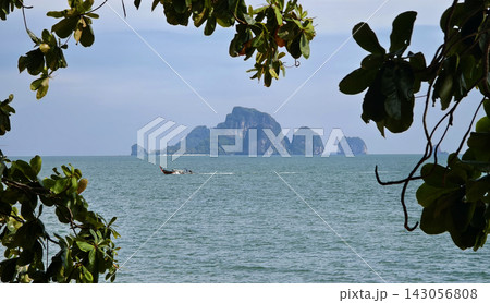 Tropical beach with calm ocean and soft blue sky above tranquil shoreline Tropical beach with calm ocean and soft blue sky above tranquil shoreline 143056808