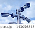 Cluster of outdoor security cameras mounted on metal pole watching property 143056848