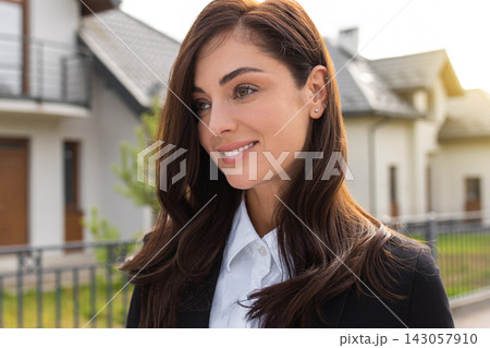Headshot of a cute long-haired young woman on a house background Headshot of a cute long-haired young woman on a house background 143057910