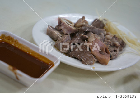 The dish of sliced cooked meat, garnished with thin slices of ginger 143059138