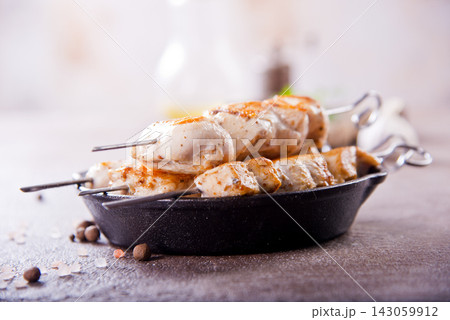 Chicken kebabs with spice on a table Chicken kebabs with spice on a table 143059912
