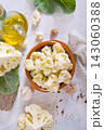 Head of cauliflower sits on a light table 143060388