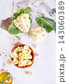 Head of cauliflower sits on a light table 143060389