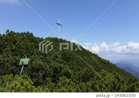 Summit cross Herzogstand mountain in Bavaria, Germany Summit cross Herzogstand mountain in Bavaria, Germany 143061850