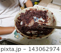 ボウルの中で小豆あんとつぶしご飯を混ぜるおはぎ作りの工程 143062974