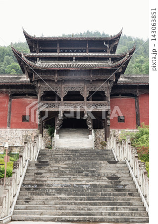 A stunning display of traditional Chinese mountain landscape design and ethnic minority engineering at Chiyou Jiuli City. This shot highlights the monumental timber-frame pavilions defined by A stunning display of traditional Chinese mountain landscape design and ethnic minority engineering at Chiyou Jiuli City. This shot highlights the monumental timber-frame pavilions defined by 143063851