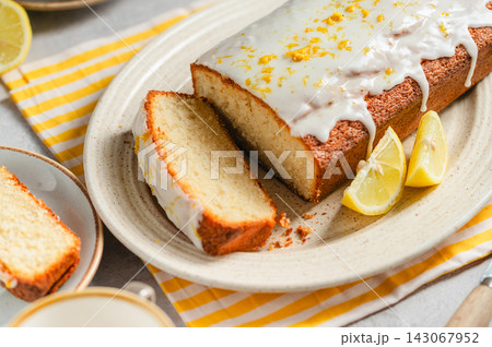 Homemade lemon loaf cake with citrus glaze, close-up lifestyle food background 143067952