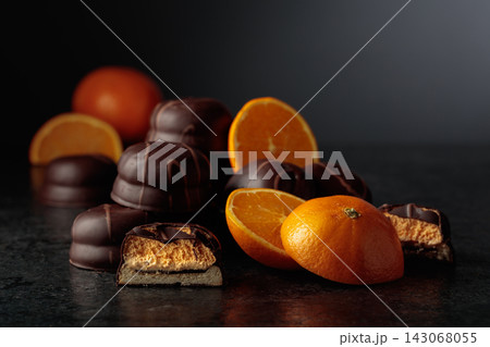 Chocolate dessert with slices of fresh oranges on a black background. 143068055