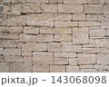 Weathered limestone wall built from rough hand cut stone blocks 143068098