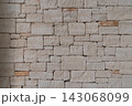 Natural limestone stone wall with irregular blocks and rustic texture 143068099