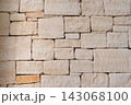 Traditional limestone wall featuring rough blocks and natural stone texture 143068100