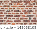 Weathered red brick wall with irregular masonry texture and pattern 143068105