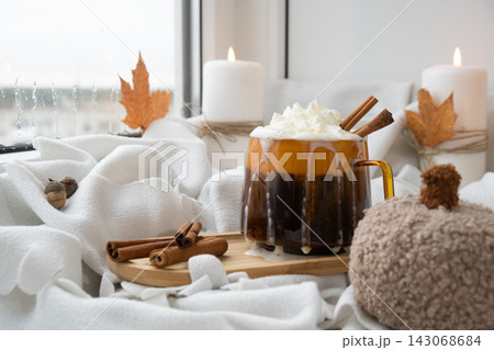Pumpkin spiced latte morning warming coffee. Fall Drinks for Halloween Thanksgiving Holiday beverage Autumn spicy cinnamon flavor seasonal hot drinking in cozy orange cup. Atmosphere of cold rainy Pumpkin spiced latte morning warming coffee. Fall Drinks for Halloween Thanksgiving Holiday beverage Autumn spicy cinnamon flavor seasonal hot drinking in cozy orange cup. Atmosphere of cold rainy 143068684
