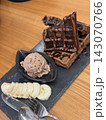 Chocolate waffles served with chocolate ice cream and fresh banana slices on slate plate 143070766