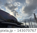 Kai Tak Sports Park main stadium architecture with sunburst and dramatic sky 143070767