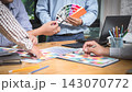 Young man holding and point to a color chart for home design. Graphic designers working on color chart at modern office. 143070772