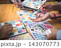 Interior designer chooses a color chart for home design. Graphic designers working on color chart at modern office. 143070773