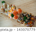 Top view of big meal with assorted and various sushi on a wooden tray in japanese restaurant. Japanese food. 143070779
