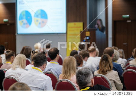 Business audience facing projected pie charts 143071389