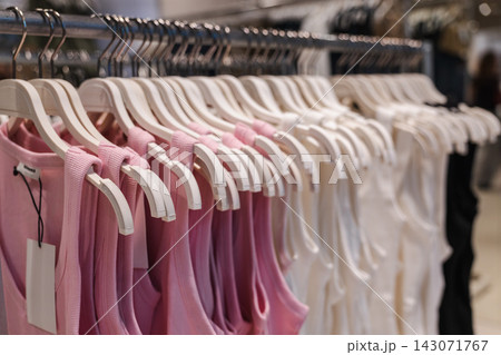 Pink and White Dresses on a Clothing Rack 143071767