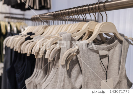 Rows of Neutral Sleeveless Tops on Clothing Rack 143071773