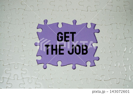 Jigsaw puzzle with a missing piece with "Get The Job" on purple background Jigsaw puzzle with a missing piece with "Get The Job" on purple background 143072601