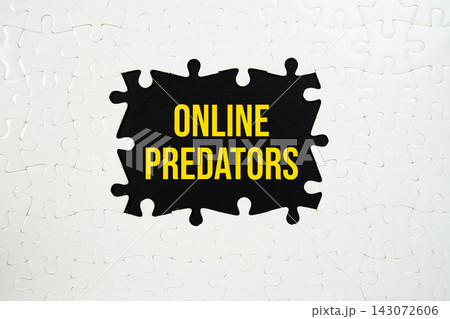 Jigsaw puzzle with a missing piece with "Online Predators" on navy blue background 143072606