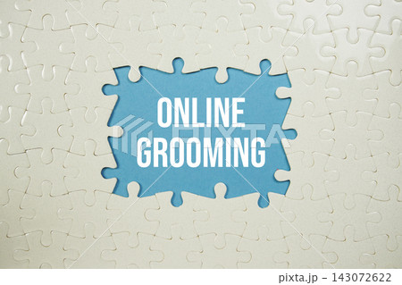 Jigsaw puzzle with a missing piece with "Online Grooming" on blue background Jigsaw puzzle with a missing piece with "Online Grooming" on blue background 143072622