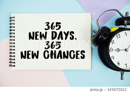365 New Days, 365 New Chances text written on notepad with alarm clock flat lay on multicolor pastel background 143072822