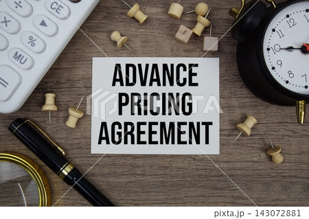 Advance Pricing Agreement text written on notepad with pen, alarm clock, magnifying glass and calculator on wooden background Advance Pricing Agreement text written on notepad with pen, alarm clock, magnifying glass and calculator on wooden background 143072881