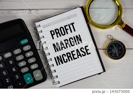 Profit Margin Increase text with calculator, magnifying glass and compass on wooden background Profit Margin Increase text with calculator, magnifying glass and compass on wooden background 143073000