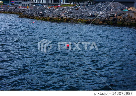 Buoys and rocky breakwater at harbor, Norway coastal waters 143073987