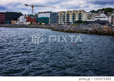 Coastal construction site with residential buildings and crane, Norway waterfront development 143073988