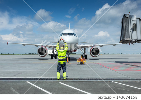 Airplane marshalling at the airport. Passenger aircraft meeting 143074158