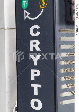 Close-up view of a vertical sign with the word crypto and currency symbols on a street kiosk. Money 143074160