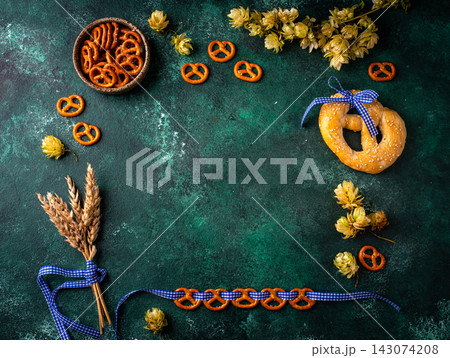 Oktoberfest background with brezel, hops and malt Oktoberfest background with brezel, hops and malt 143074208